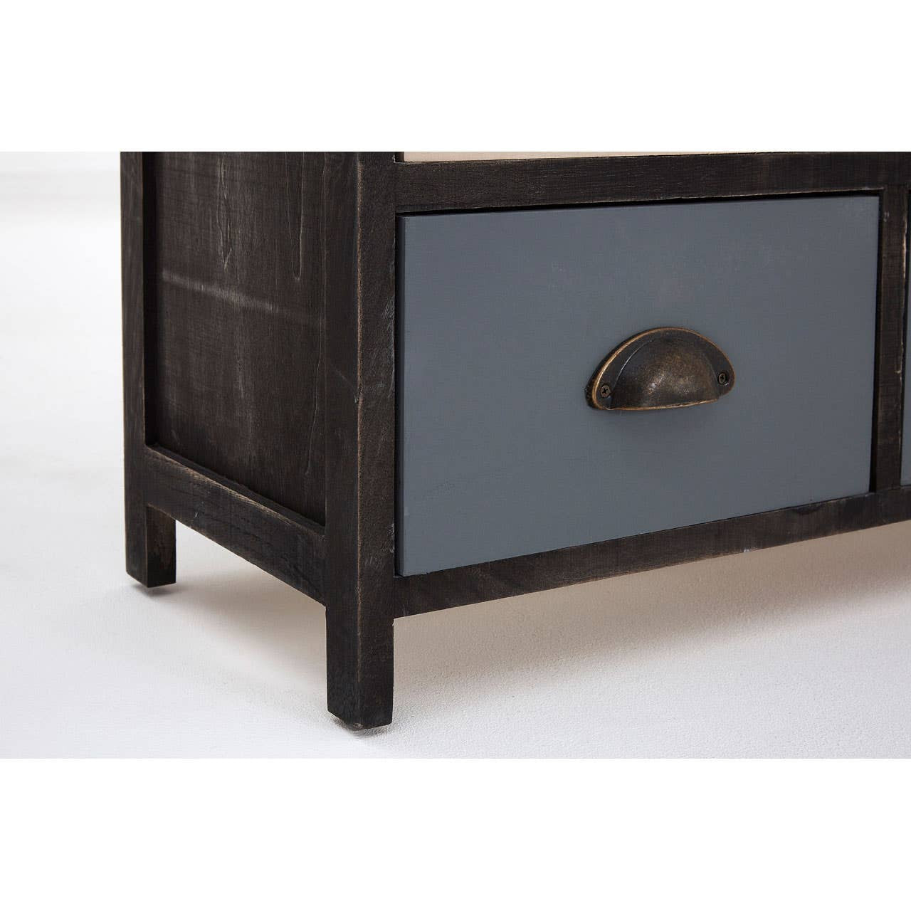 A close-up view of the Urban Loft 6 Drawers Chest, showcasing a dark wood frame with a blue drawer front. The drawer features a round metal handle, and the overall design has a modern, industrial aesthetic. The chest is positioned on a light-colored surface, highlighting its contrasting colors
