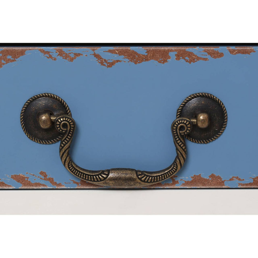 Close-up view of a blue side table featuring a decorative design and an antique-style brass handle. The handle is mounted on a contrasting surface, highlighting the craftsmanship and color contrast of the piece