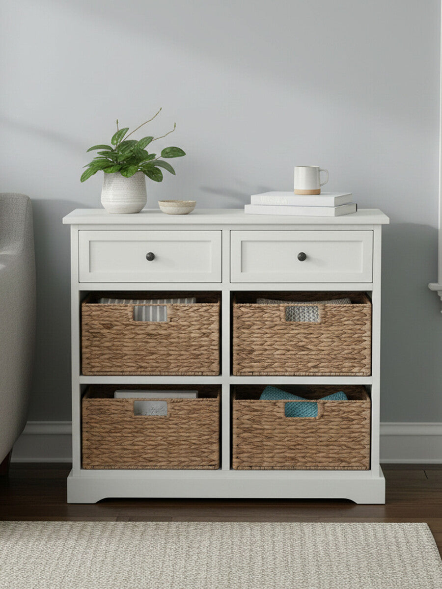 Vermont Ivory cabinet featuring two upper drawers and four woven baskets in a natural finish, set against a light-colored wall with a small potted plant and decorative items on top. The cabinet has a clean, modern design with a smooth surface and subtle hardware