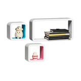 Three white floating wall cubes in varying sizes, featuring a decorative sheep figurine in one cube, stacked books in another, and a red chair illustration in the smallest cube. The cubes are designed for wall mounting and showcase a modern aesthetic