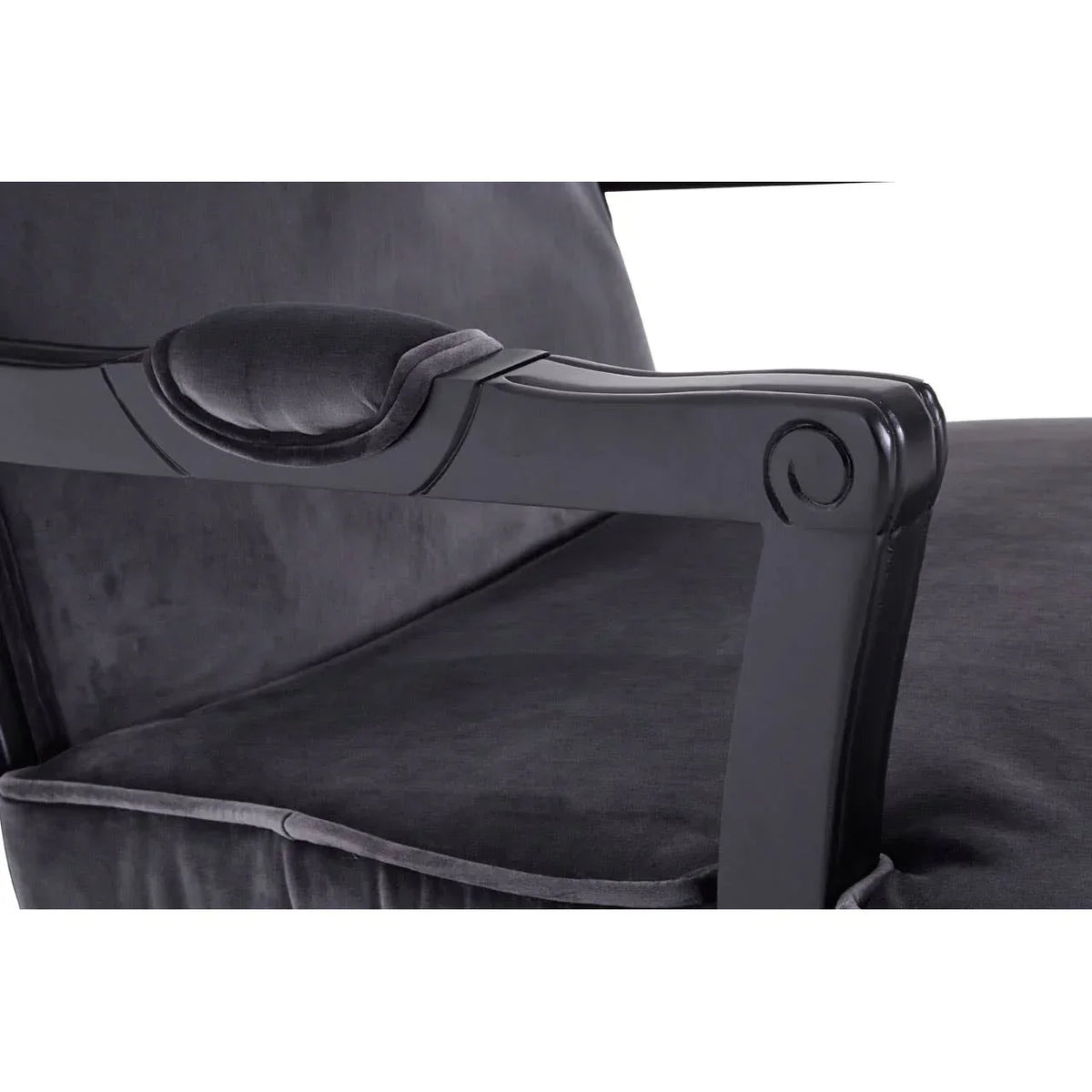 Close up of black velvet armchair with padded armrest and wooden frame detail