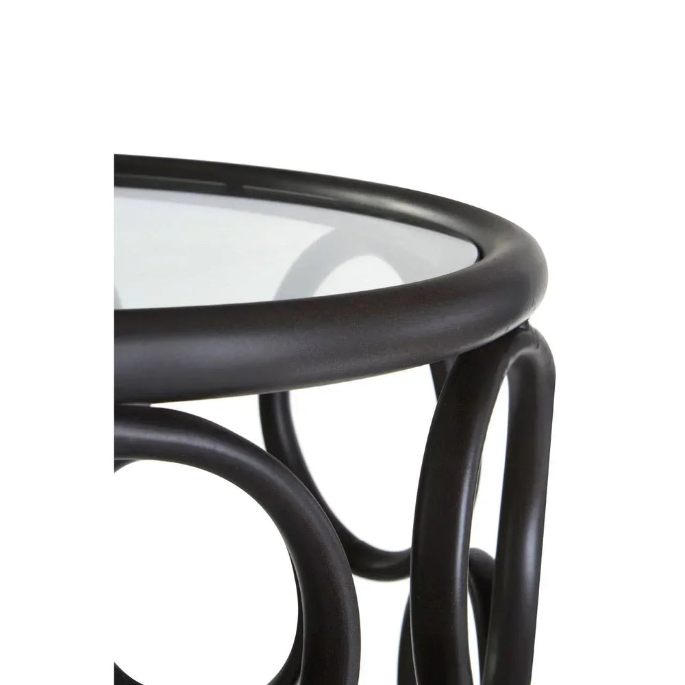 Round glass top side table with dark rattan frame and curved leg details
