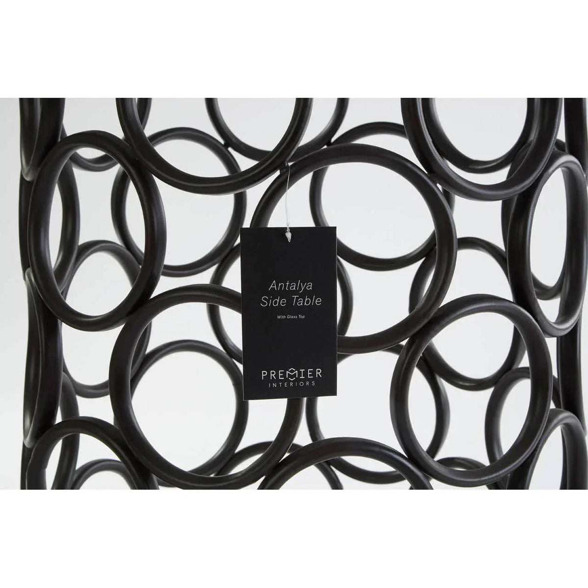 Black metal Antalya side table with circular frame design and product tag close-up