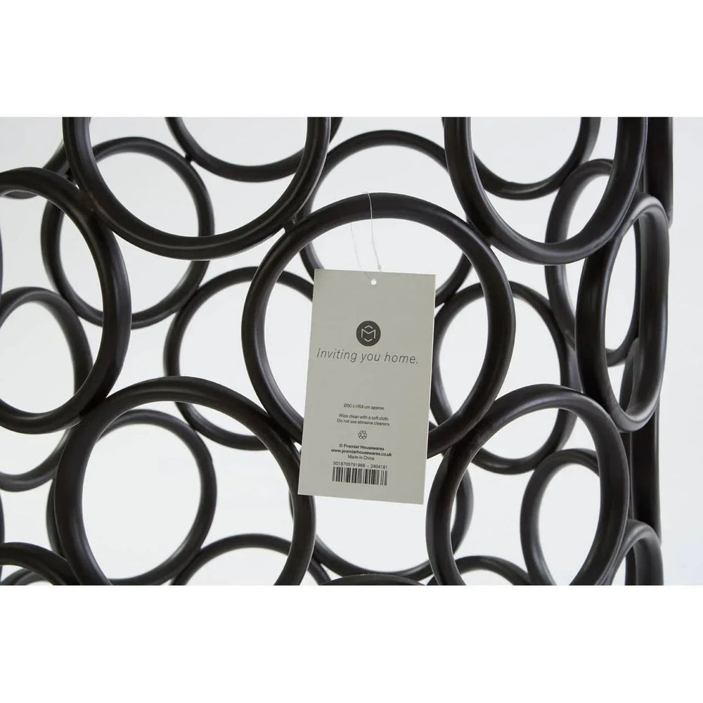 Black metal wine rack with circular design and product tag attached