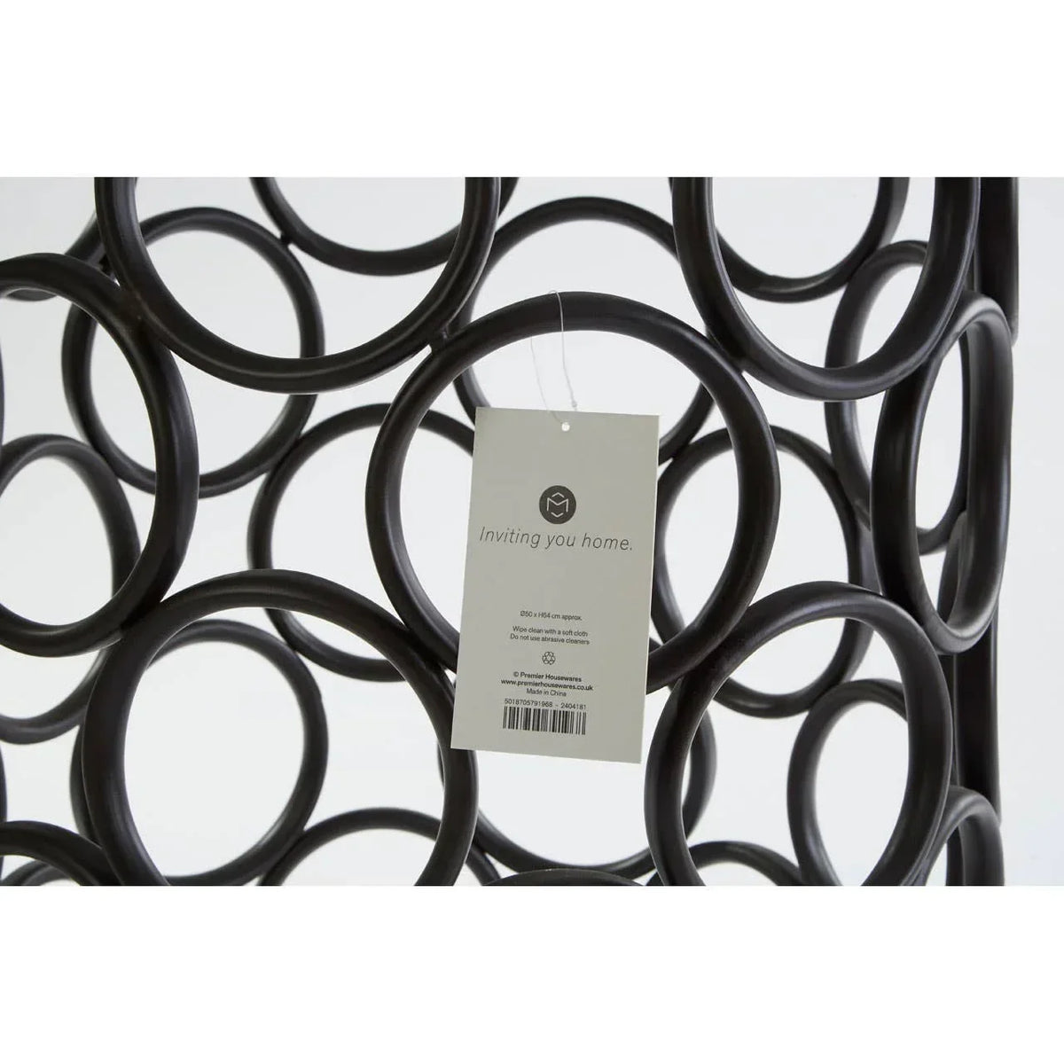 Black metal wine rack with circular design and product tag attached