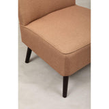 Close up of tan fabric armchair seat with black wooden legs on light floor