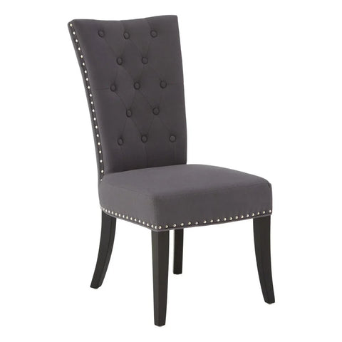 Grey upholstered dining chair with button-tufted backrest and nailhead trim, front angle view