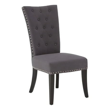 Grey upholstered dining chair with button-tufted backrest and nailhead trim, front angle view