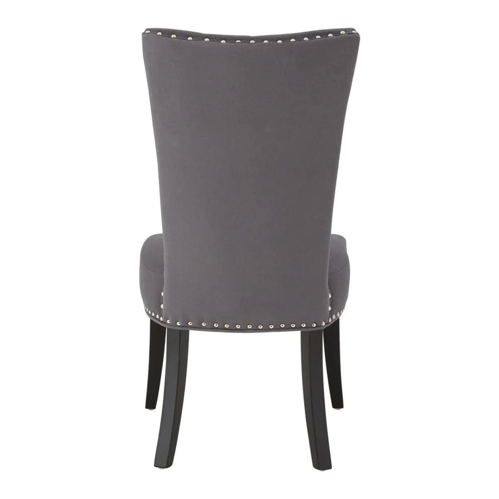 Grey upholstered dining chair rear view with silver stud trim and black wooden legs