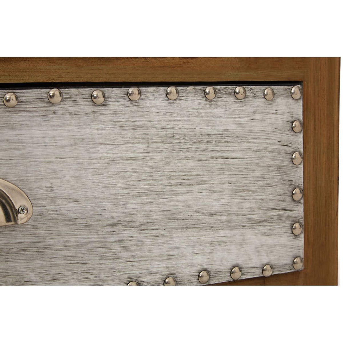 Close up of metal drawer front with brushed finish and studded detailing