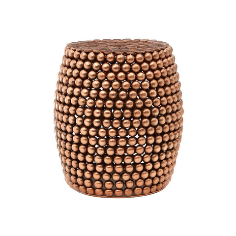 Copper finish barrel stool with a textured surface featuring a pattern of small, raised dots, creating a stylish and modern look. The stool has a rounded shape and a sturdy base, suitable for use as extra seating or a decorative accent in home interiors