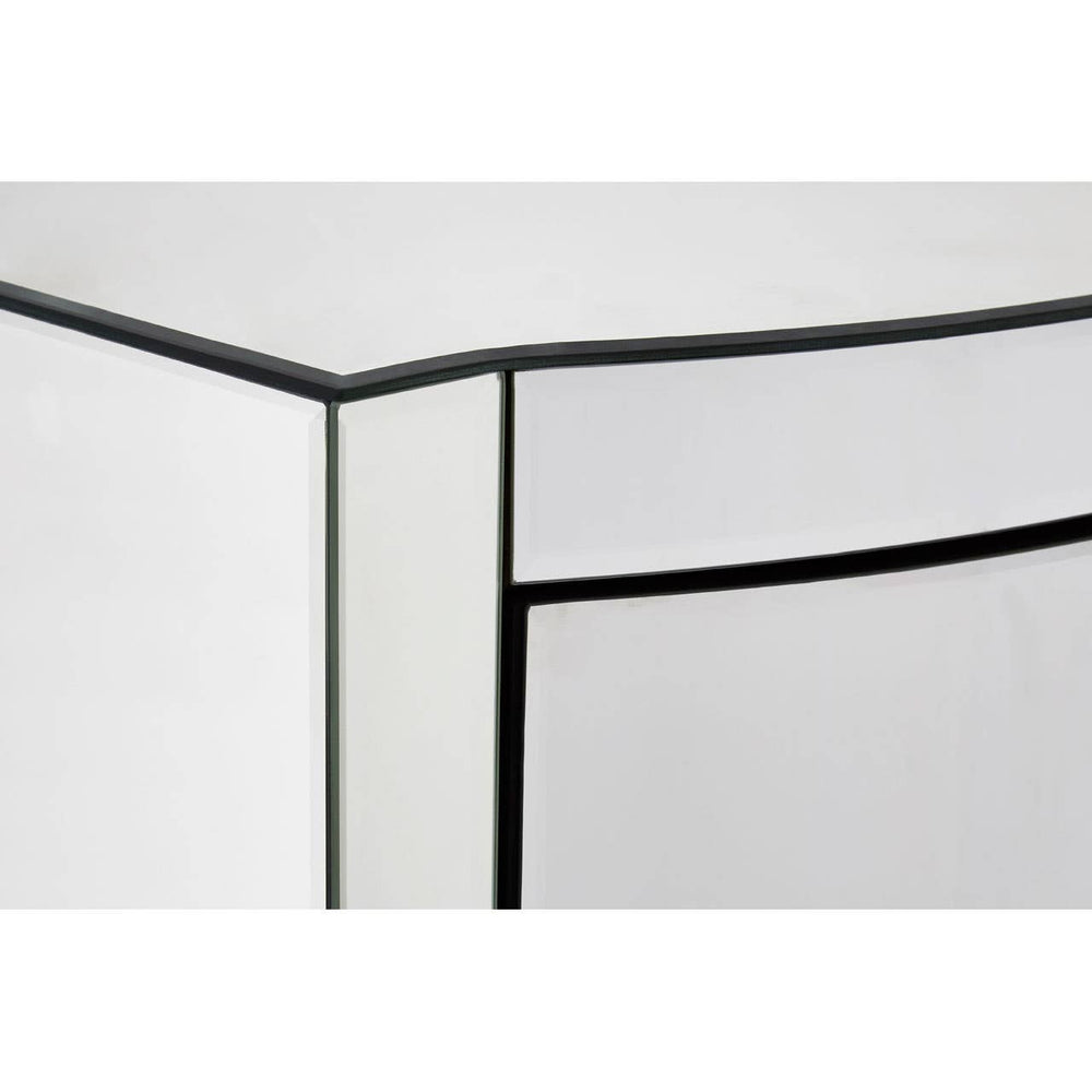 Close-up view of the corner of a tall boy drawer with a sleek, curved design, featuring a glossy white finish and contrasting black edges. The drawer front is smooth and minimalistic, emphasizing modern aesthetics