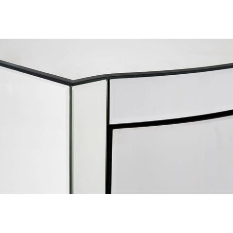 Close-up view of the corner of a tall boy drawer with a sleek, curved design, featuring a glossy white finish and contrasting black edges. The drawer front is smooth and minimalistic, emphasizing modern aesthetics