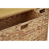 A close-up view of the Padstow Storage Unit featuring a natural wood top and six woven water hyacinth drawers. One drawer is partially pulled out, showcasing its textured surface and cut-out handle. The overall design highlights a blend of natural materials and a functional storage solution