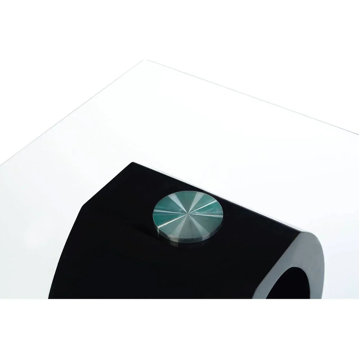 Close up of clear glass coffee table top with black base and chrome accent detail