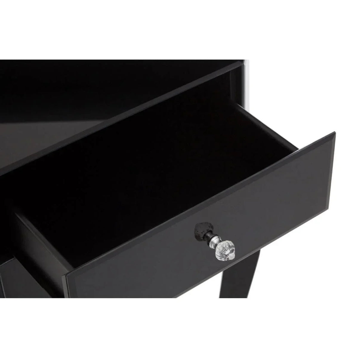 Black bedside table with open drawer and crystal handle, glossy finish, close-up view