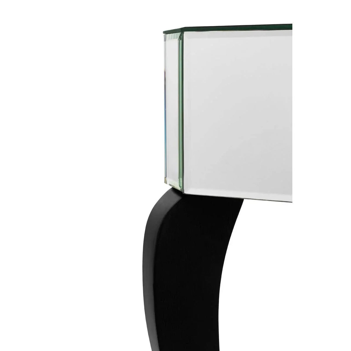 Close-up of mirrored console table corner with curved black leg detail