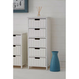 White wooden tall chest of drawers with five drawers and black handles in a modern room