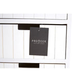 White wooden storage drawers with vertical panel design and black handle cutouts