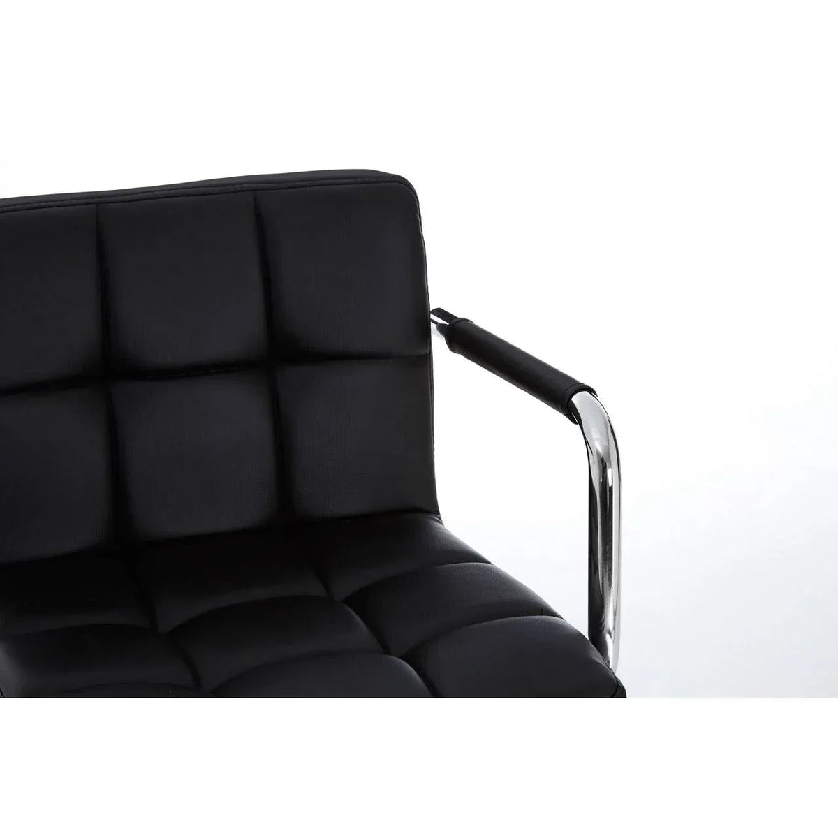 Black leather dining chair with padded seat and chrome metal armrest close-up