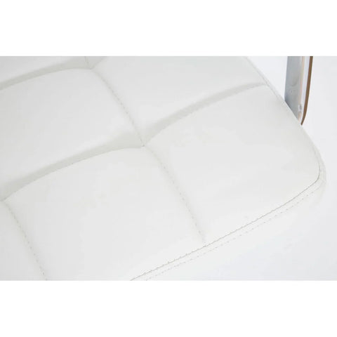 Close-up of white leather dining chair seat with square stitched detail