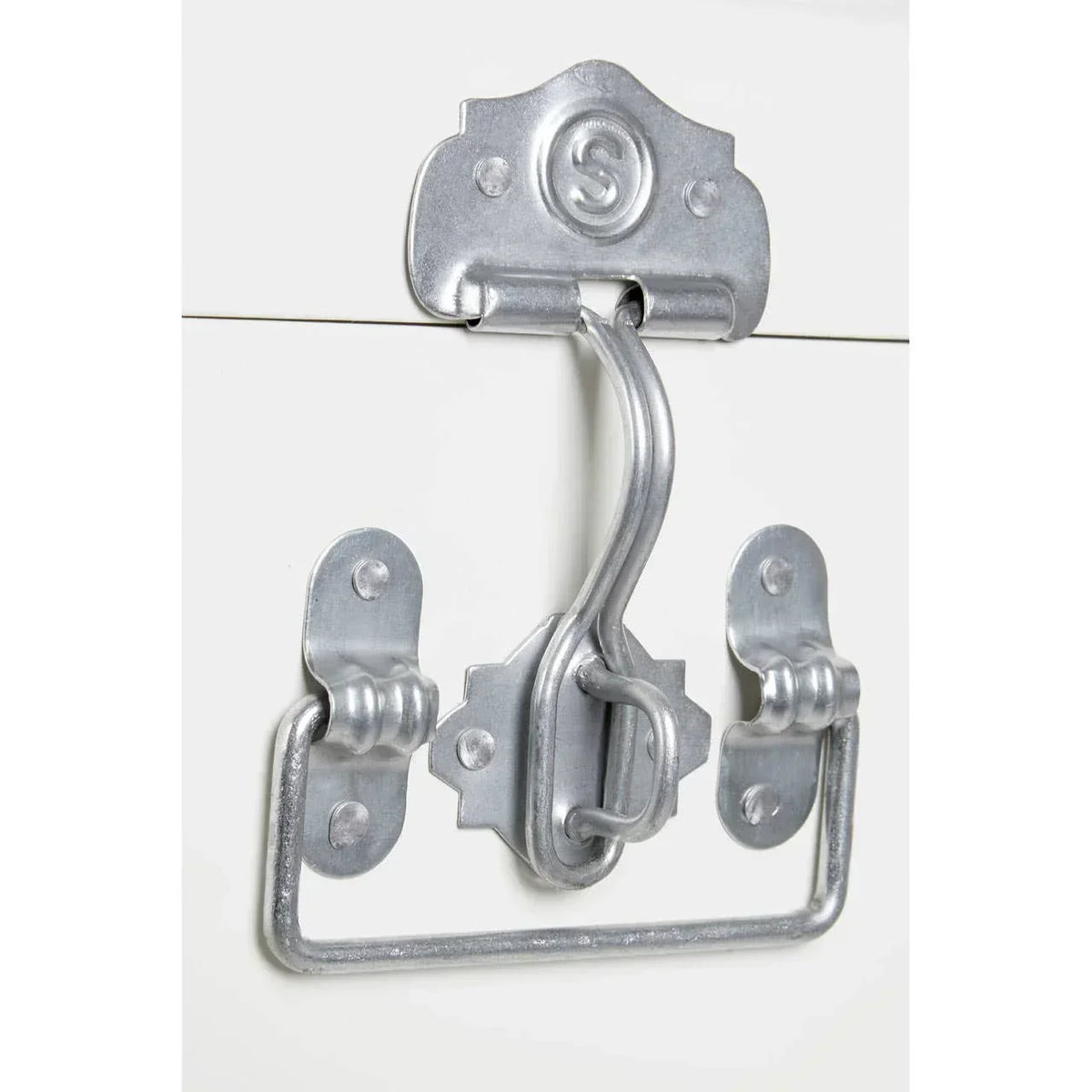 Close-up of metal trunk handle and latch on white storage furniture