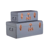 Set of two grey metal storage trunks with copper latches and side handles, stacked together