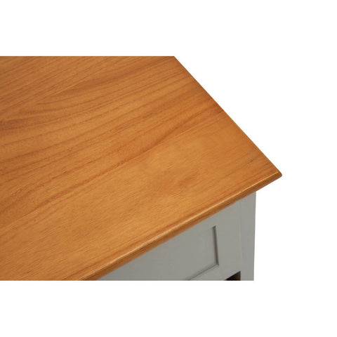 The top surface of a cabinet featuring a smooth, warm-toned wooden finish, with a slight overhang at the edges. The cabinet has a light gray body and is designed to hold two drawers and four woven baskets for storage