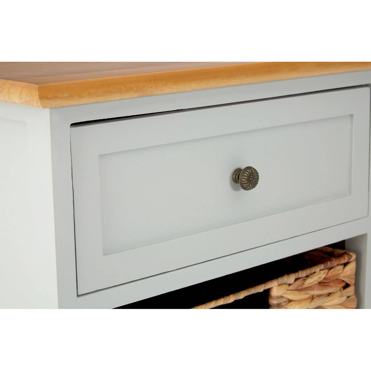 Light gray cabinet featuring a single drawer with a round bronze knob and two woven baskets below. The top surface is a natural wood finish, providing a contrast to the gray body of the cabinet