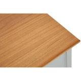 Top view of a wooden cabinet featuring a smooth, light brown surface with a natural grain pattern, showcasing a corner edge