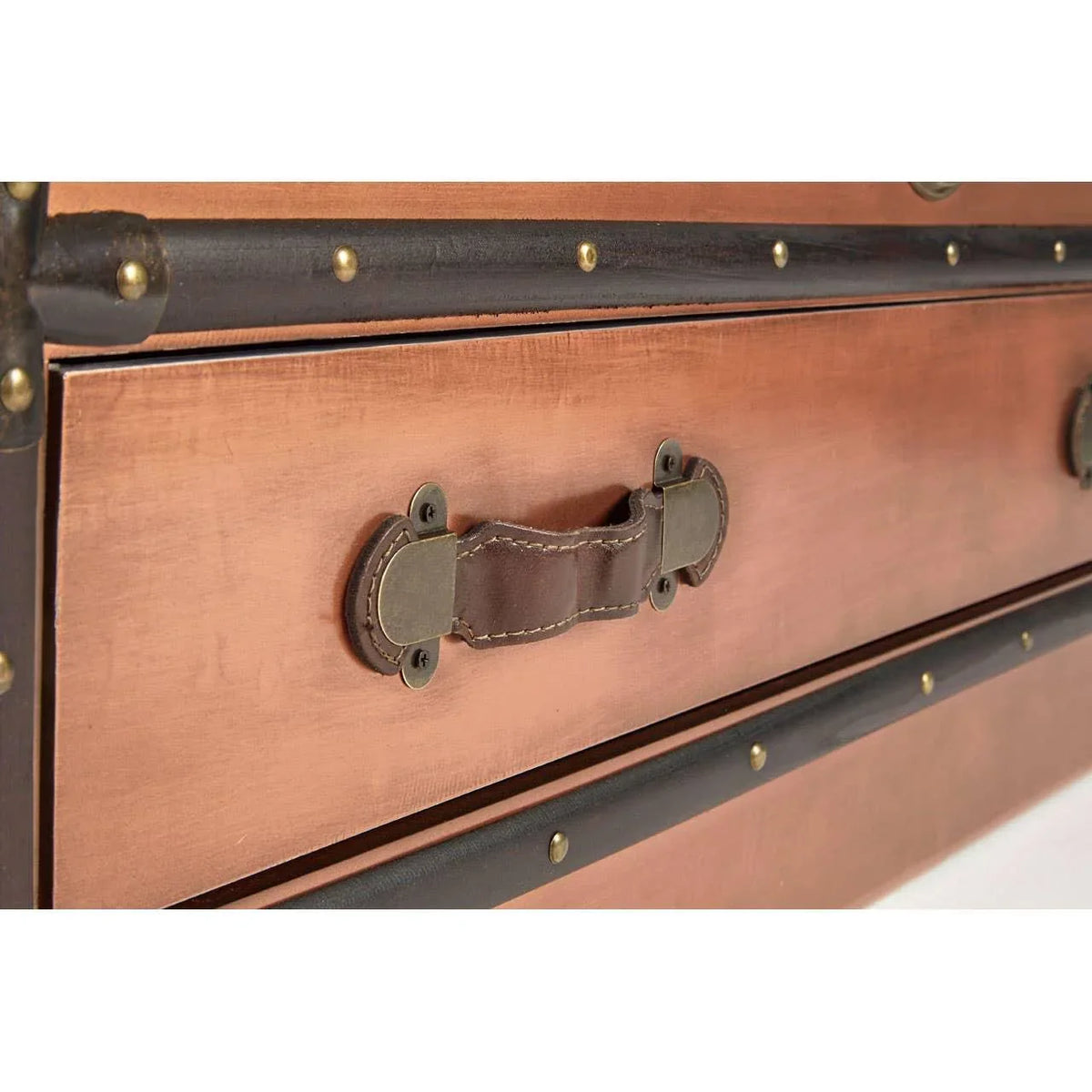 Closeup of vintage wood chest drawer with leather handle and metal rivet details