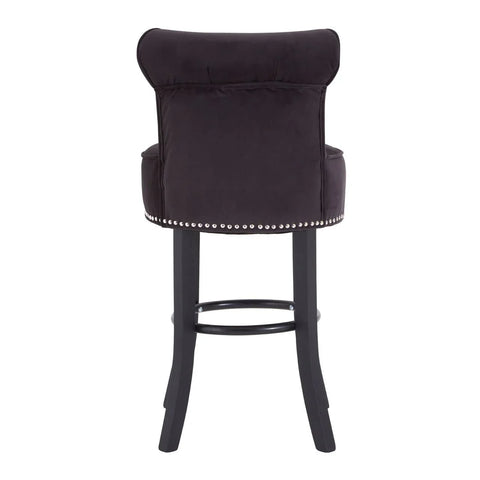 Black velvet bar stool with studded trim and dark wooden legs, rear view