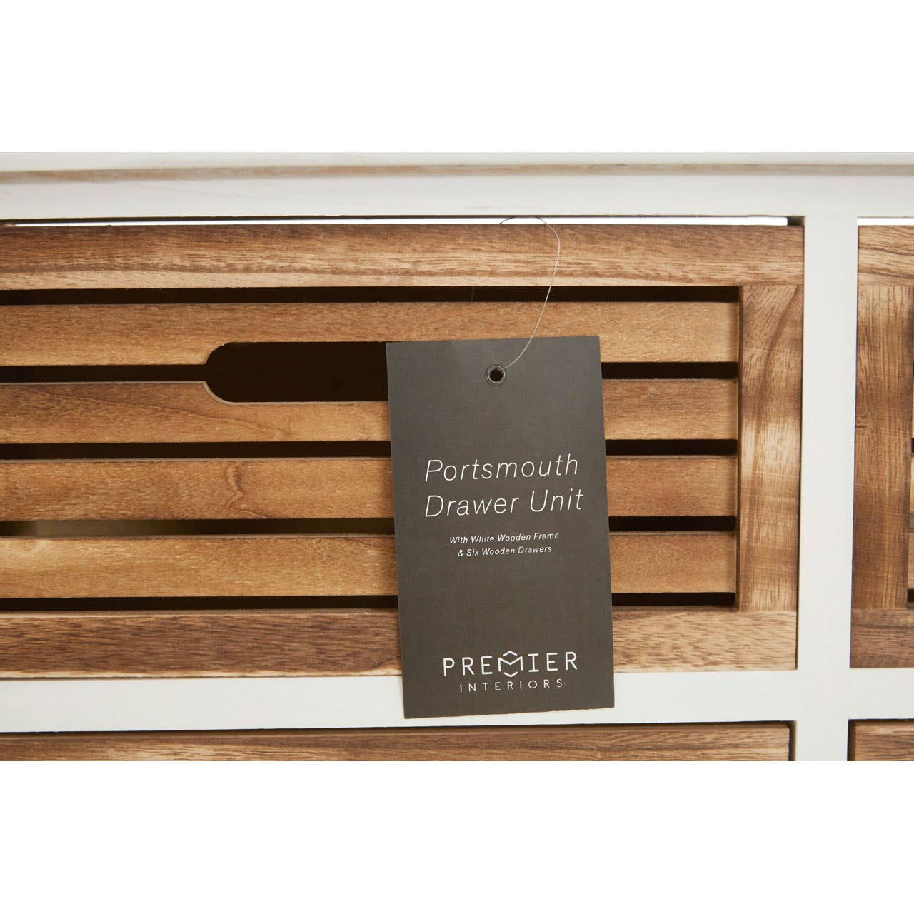 Portsmouth 6 Drawers Unit featuring a white frame with wooden drawer fronts, showcasing six spacious drawers with horizontal slats and a tag attached that displays the product name and brand