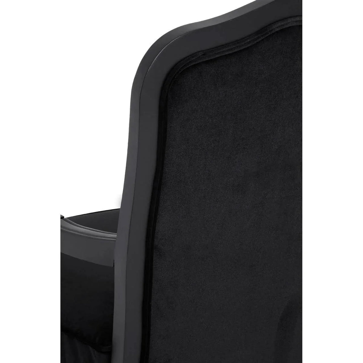 Black velvet dining chair backrest with curved wooden frame closeup