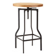 Round ash veneer tabletop with a natural wood finish, supported by a sleek black metal frame featuring a unique, curved design and a footrest for added comfort