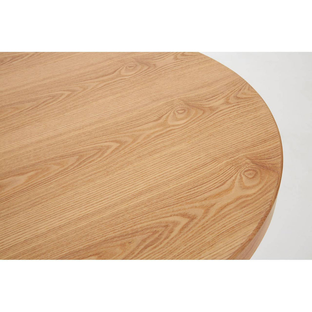 Close-up view of the round tabletop of the New Foundry Ash Veneer Bar Table, showcasing a smooth, light wood finish with natural grain patterns and a subtle sheen