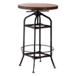 Round walnut tabletop supported by a black metal frame with a circular footrest and two lower shelves, featuring a vintage industrial design. The table has a sturdy base with four legs that taper downwards