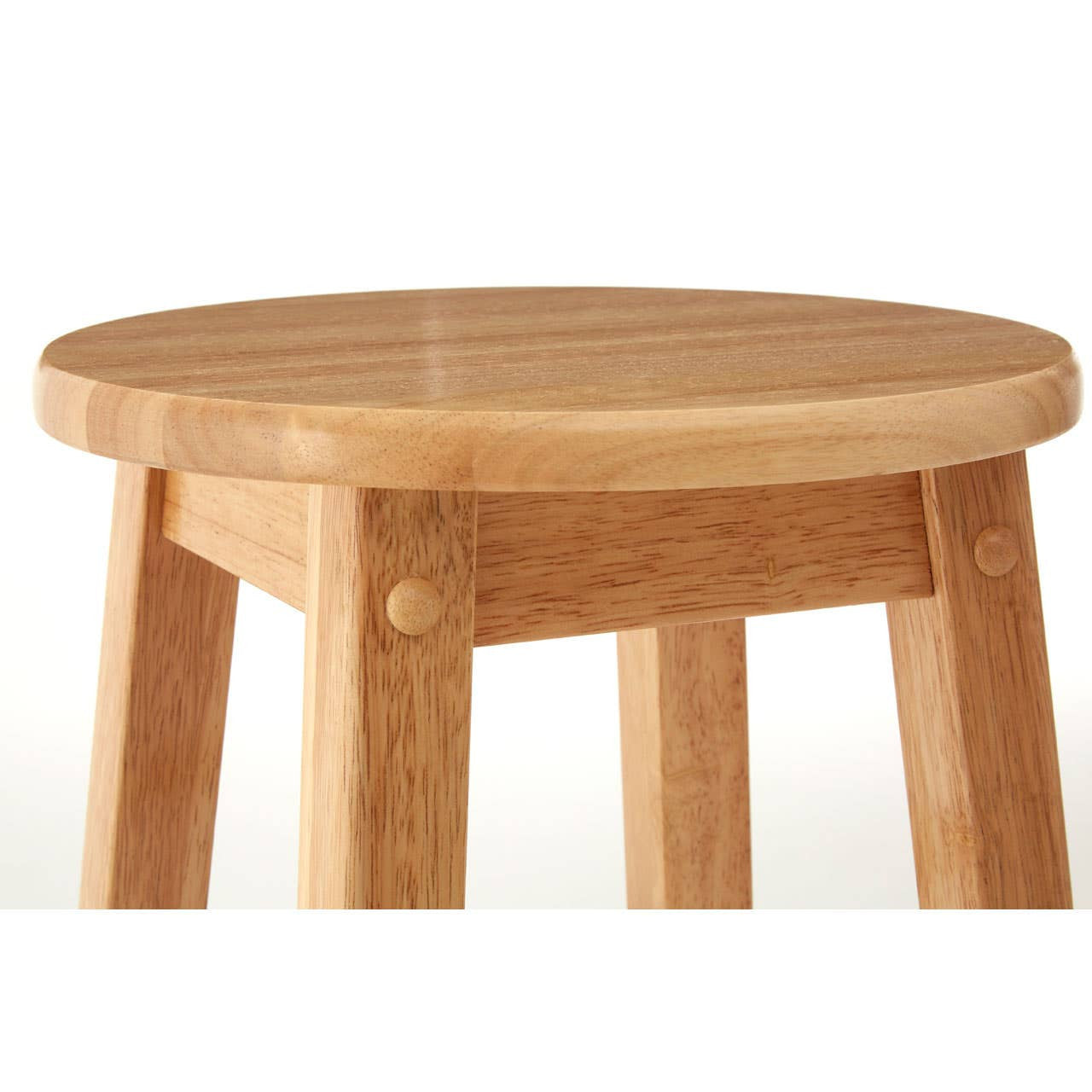 Round wooden seat of a tall bar stool made from natural tropical Hevea wood, featuring four sturdy legs and a smooth surface. The wood has a light, warm finish that highlights its natural grain