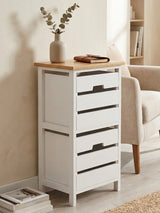 A white two-drawer chest with a natural wood top, featuring sleek black handles, positioned against a light-colored wall. A small vase with dried flowers sits on top, and a cozy armchair is visible in the background