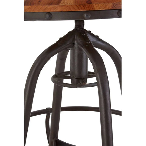 Industrial bar stool with black metal legs and wood seat, close-up of base and footrest