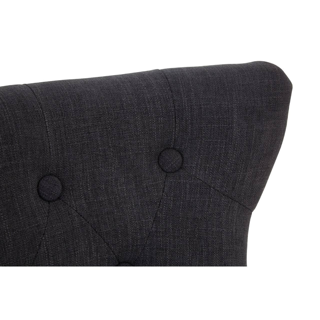 Dark fabric upholstered chair back with button tufting detail