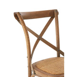 Oak dining chair with cross back design and woven rattan seat, partial side view