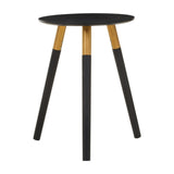 Round side table with a black top and three wooden legs, two of which are black and one is natural wood. The design is modern and minimalist, suitable for various home decor styles