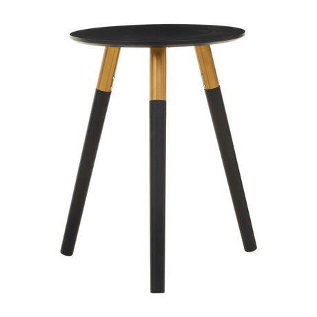 Round side table with a black top and three wooden legs, two of which are black and one is natural wood. The design is modern and minimalist, suitable for various home decor styles