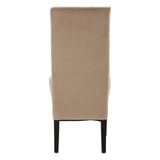Beige upholstered dining chair rear view with high back and dark wooden legs