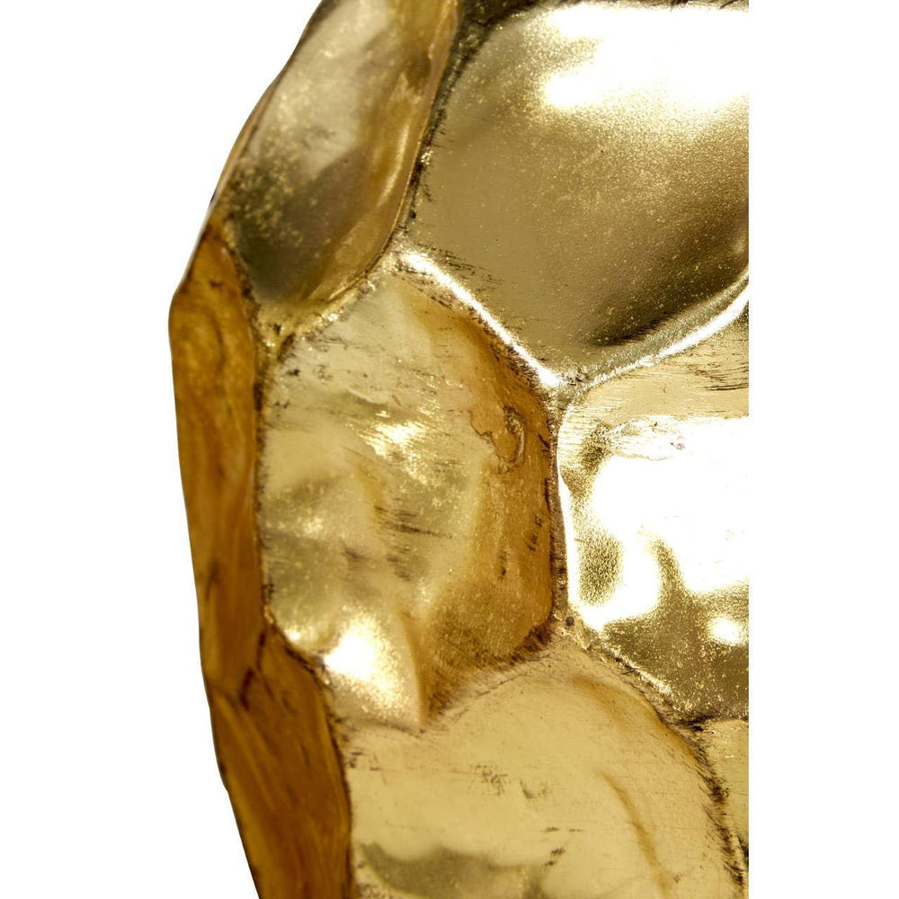 Textured gold metallic surface detail on decorative furniture piece