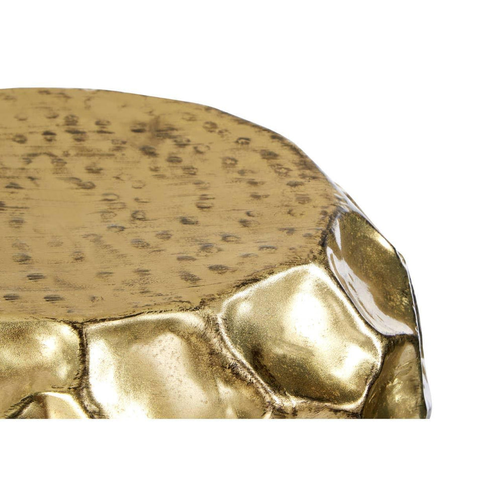 Close up of hammered gold accent table top with textured and irregular edge