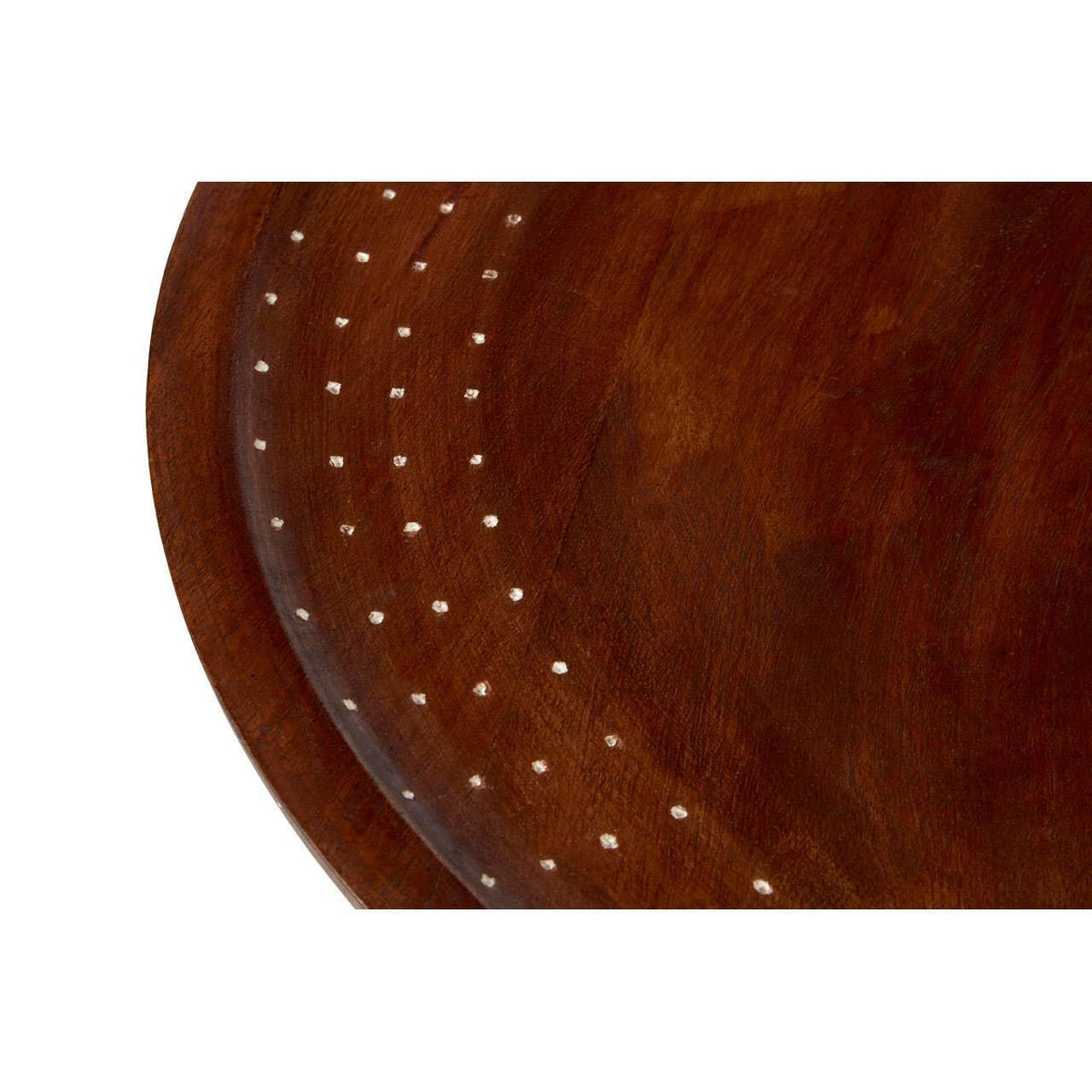 Close-up of round wooden table top with dotted inlay detail