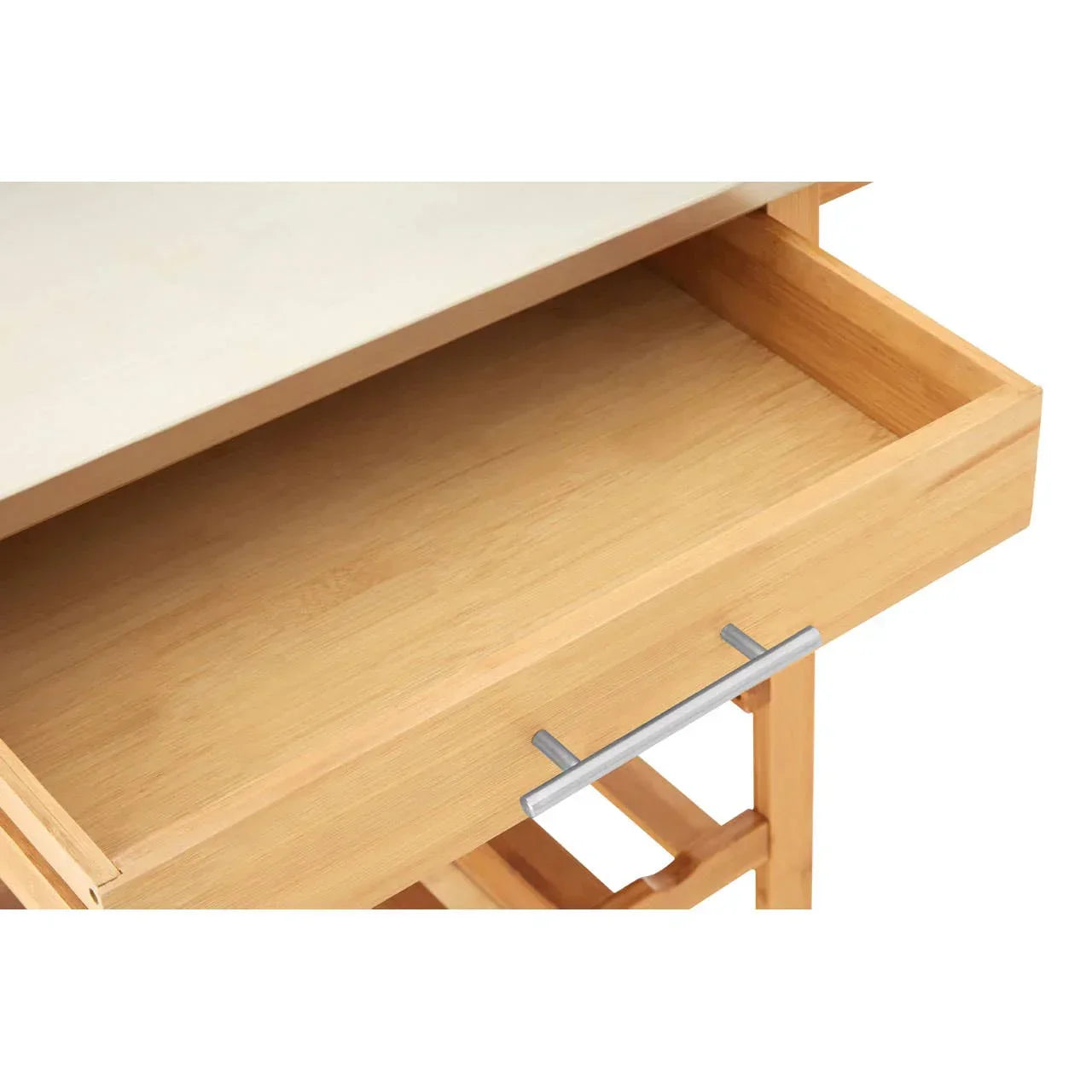 Open wooden drawer with metal handle on light wood kitchen cart