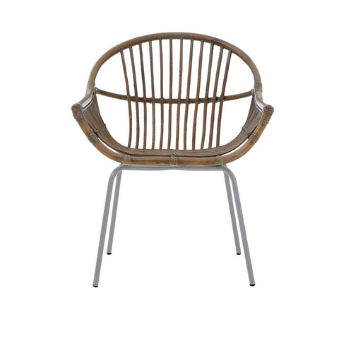 A grey wash natural rattan chair with a rounded backrest and slender vertical slats, supported by sleek metal legs. The chair features a comfortable, open design suitable for various home settings
